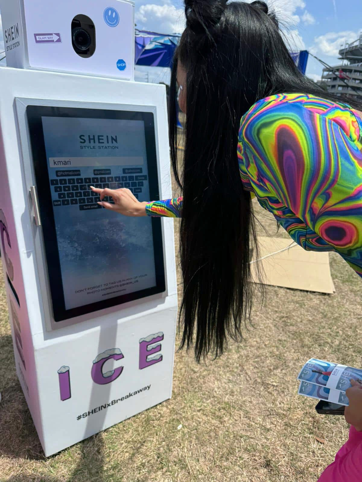 Guest using the faux ice-machine SHEIN photo booth