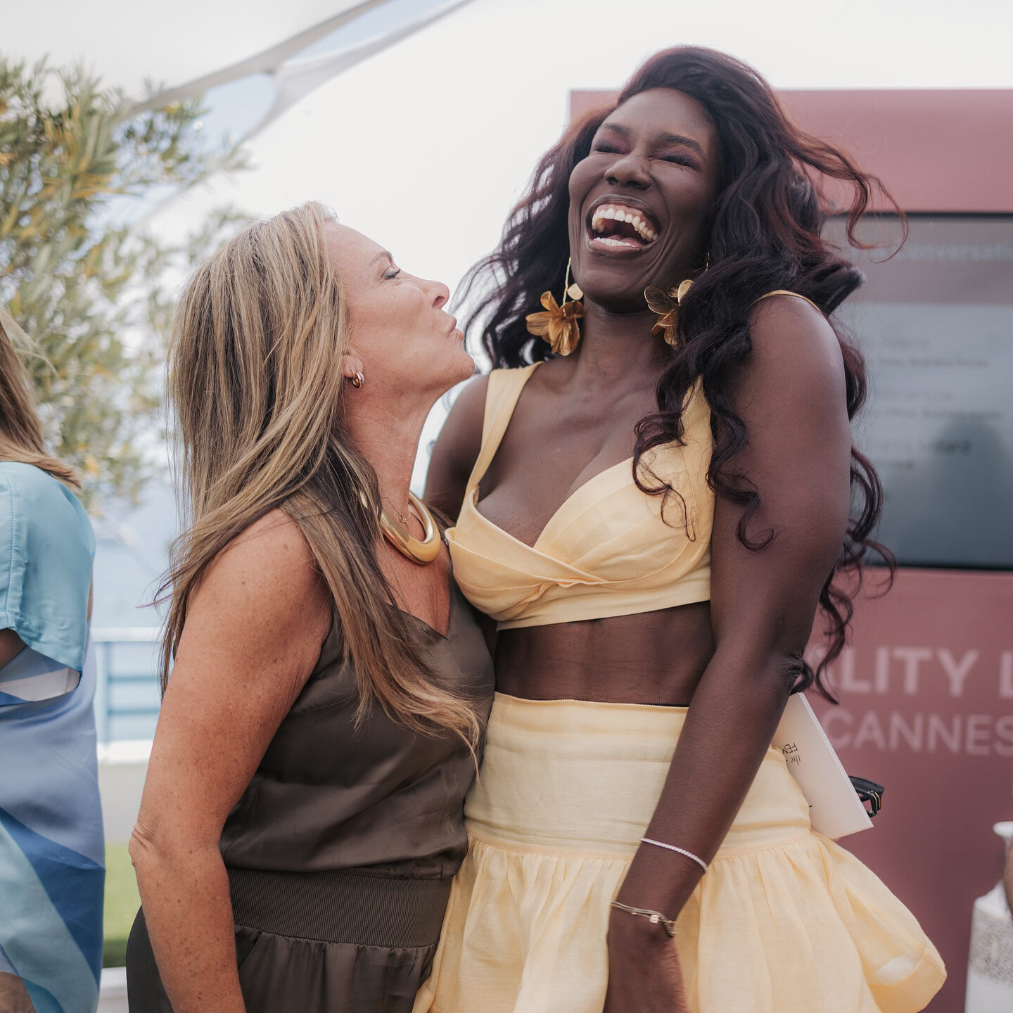 Two guests sharing a joyful moment on the Equality Lounge terrace