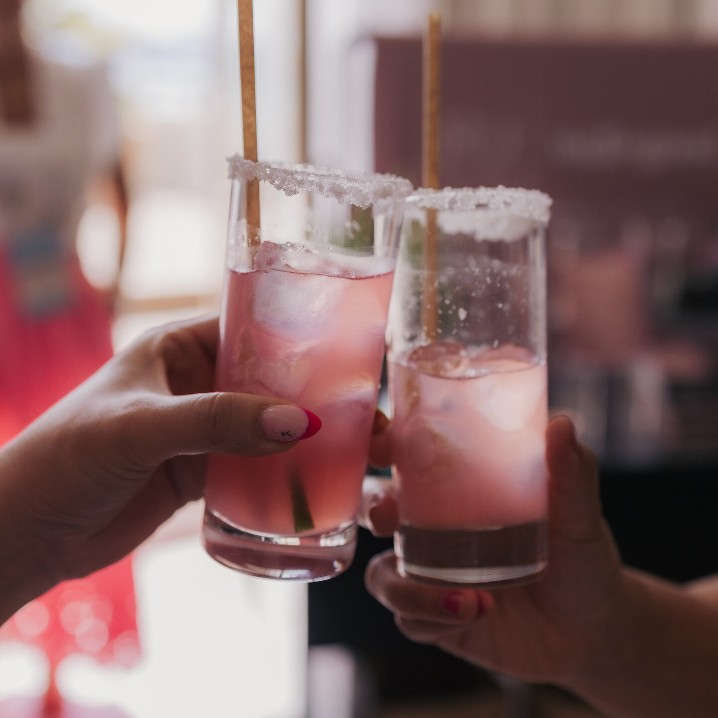 Guests toasting with pink Equality Lounge cocktails