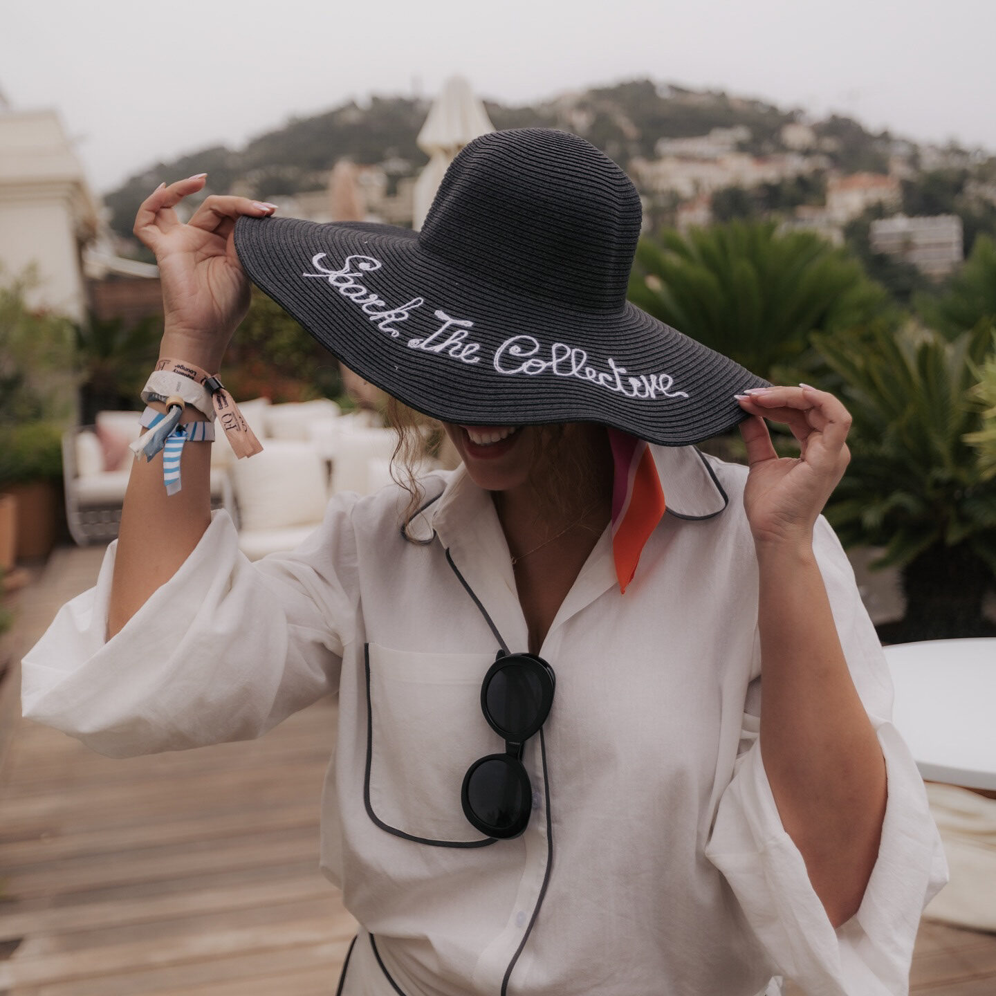 Guest showing a personalized Speak The Collective hat at the Equality Lounge