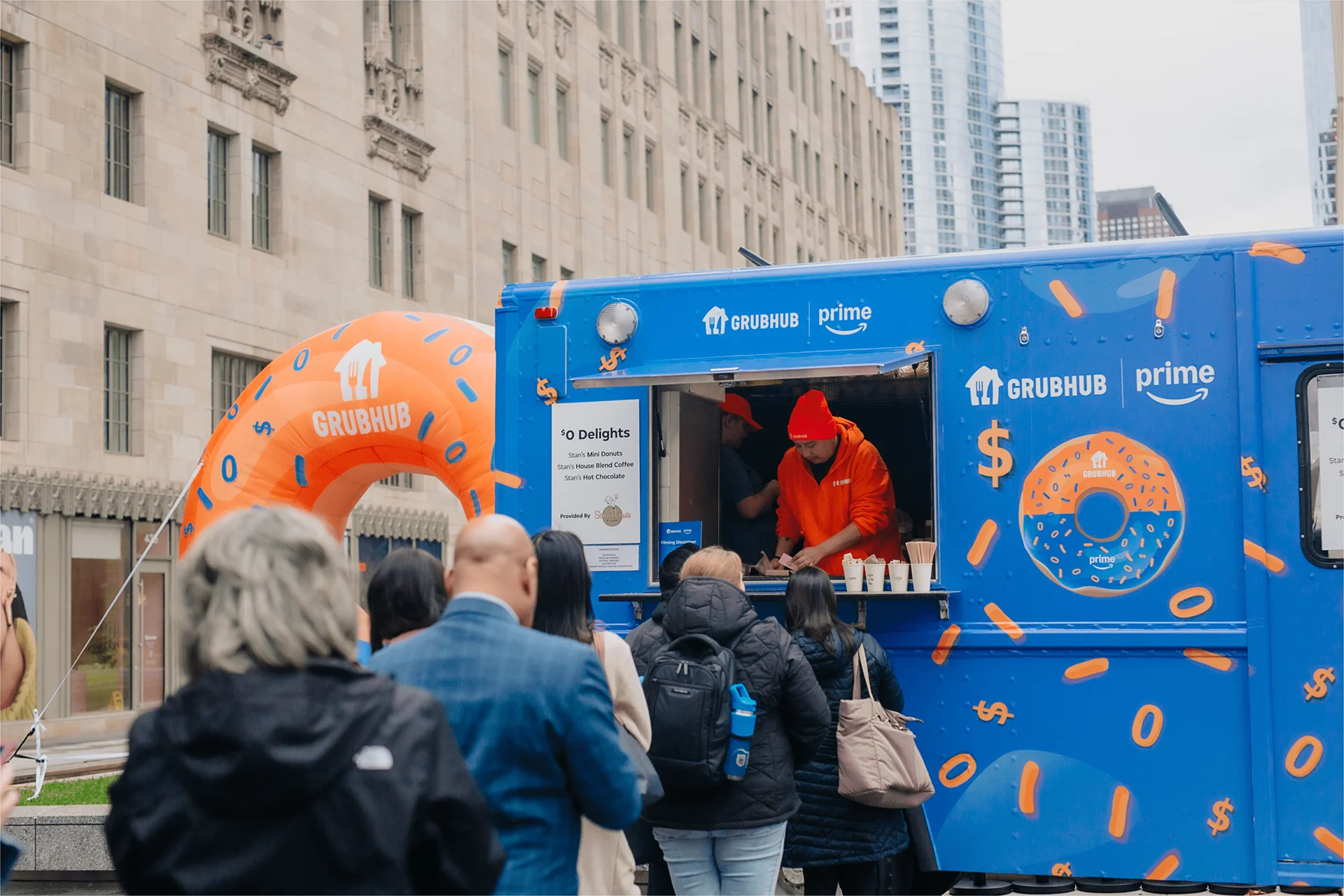 GrubHub x Amazon Prime branded food truck serving a crowd in downtown Chicago