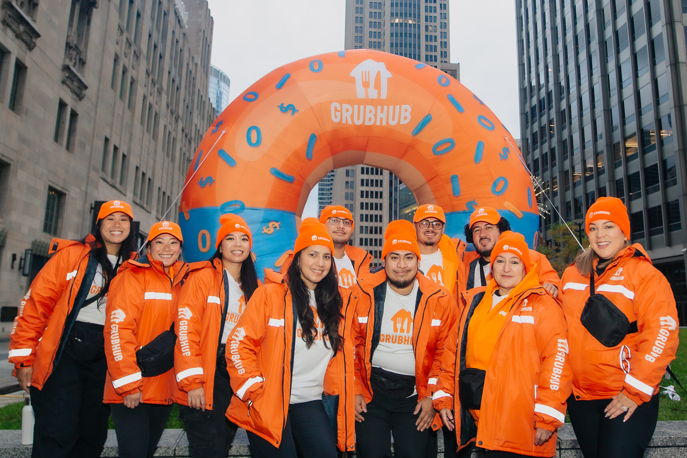 The Brand Ambassador team posing under the giant inflatable GrubHub donut