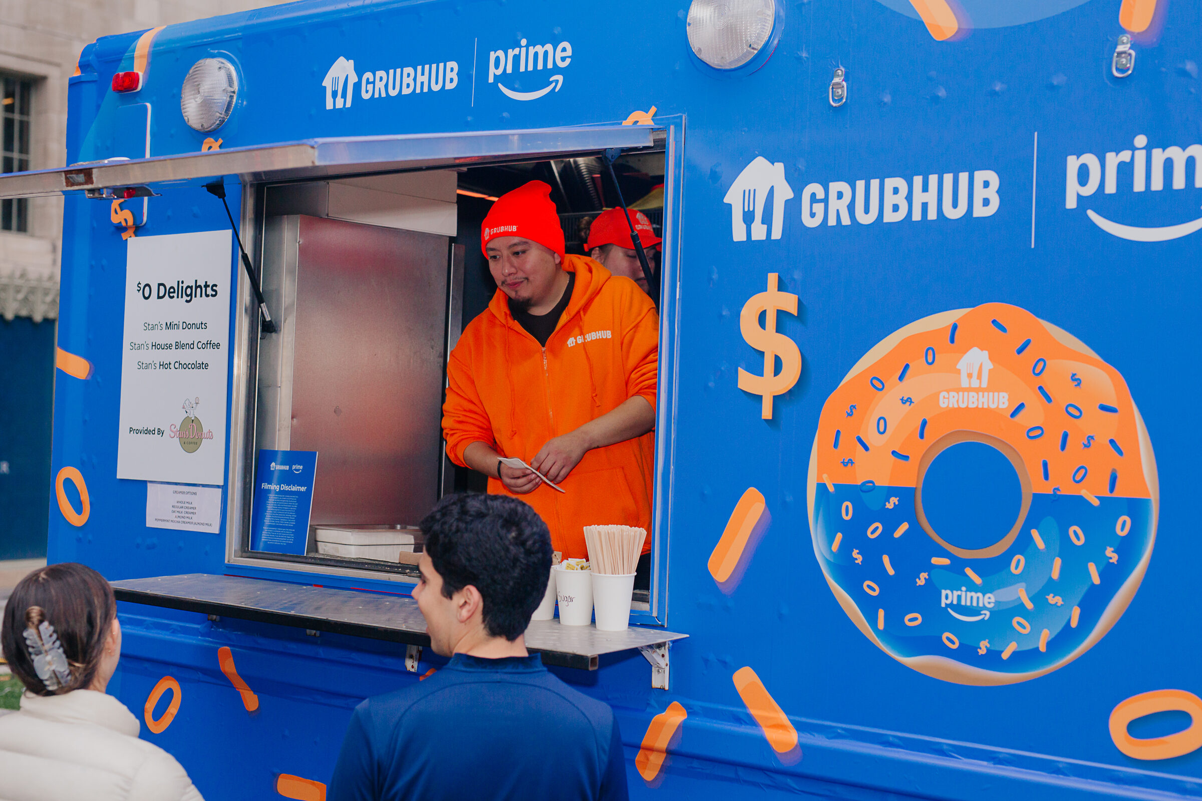 Fully wrapped GrubHub x Prime food truck with donut and dollar-sign graphics