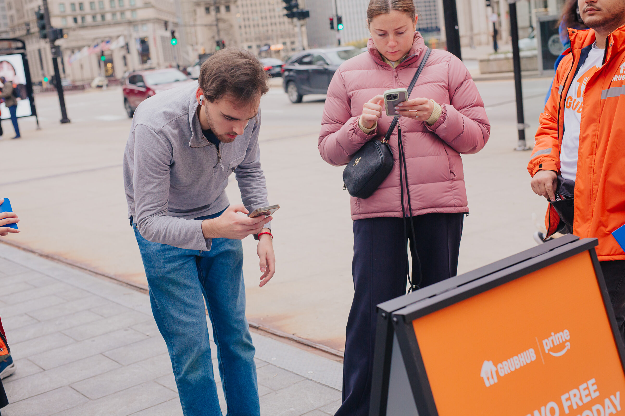 Guests signing up for Grubhub+ beside the gift card A-frame