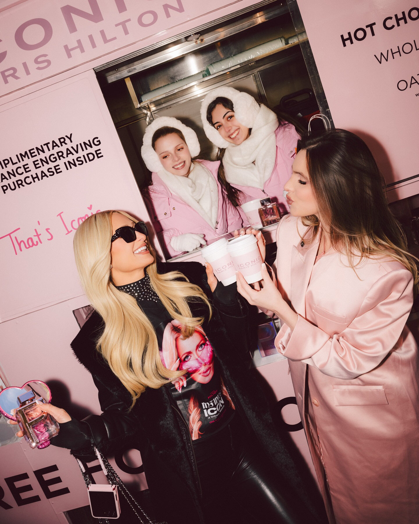 Paris Hilton toasting pink cups at the ICONIC hot chocolate stand