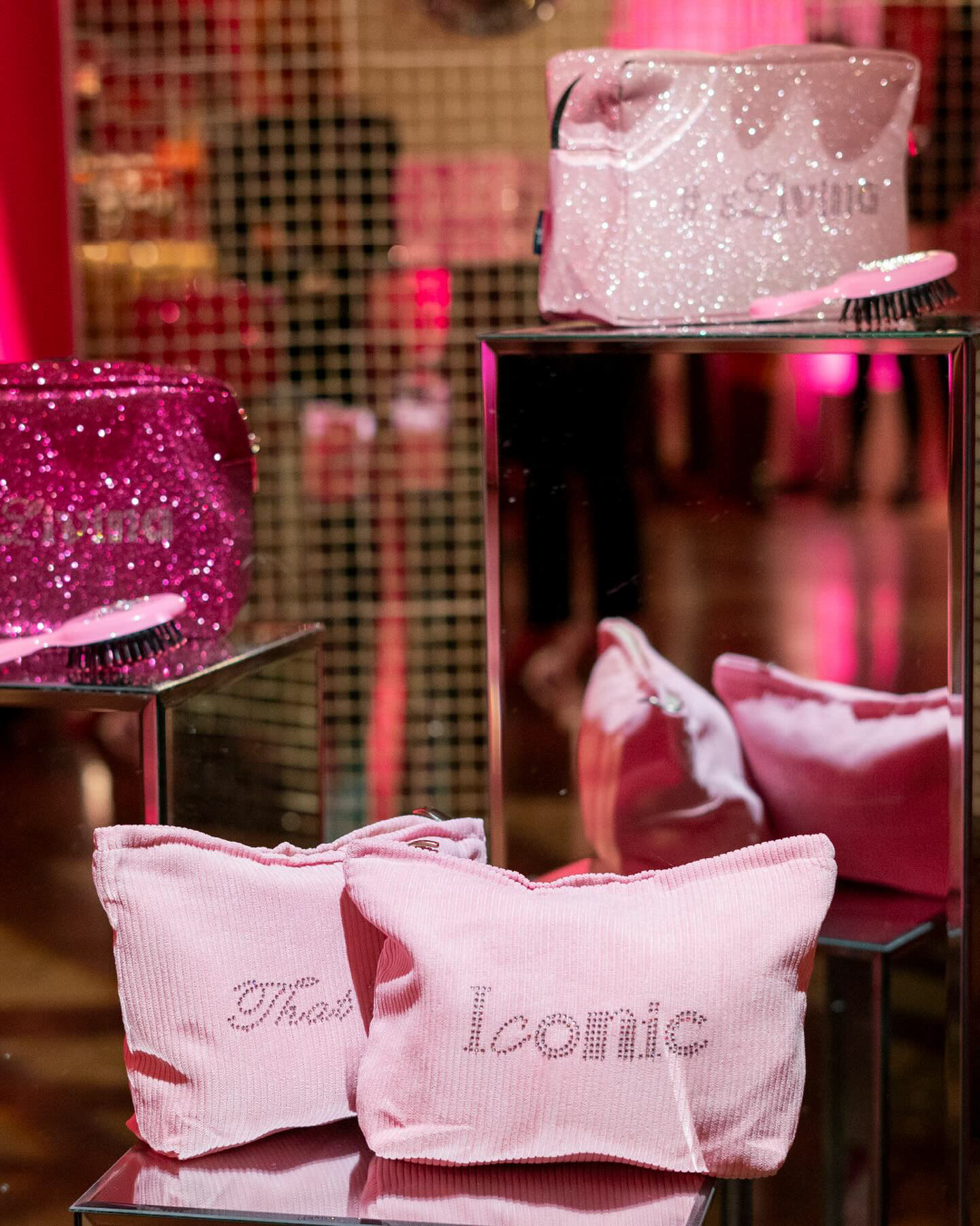 Sparkling pink accessories and pillows reading That's and Iconic