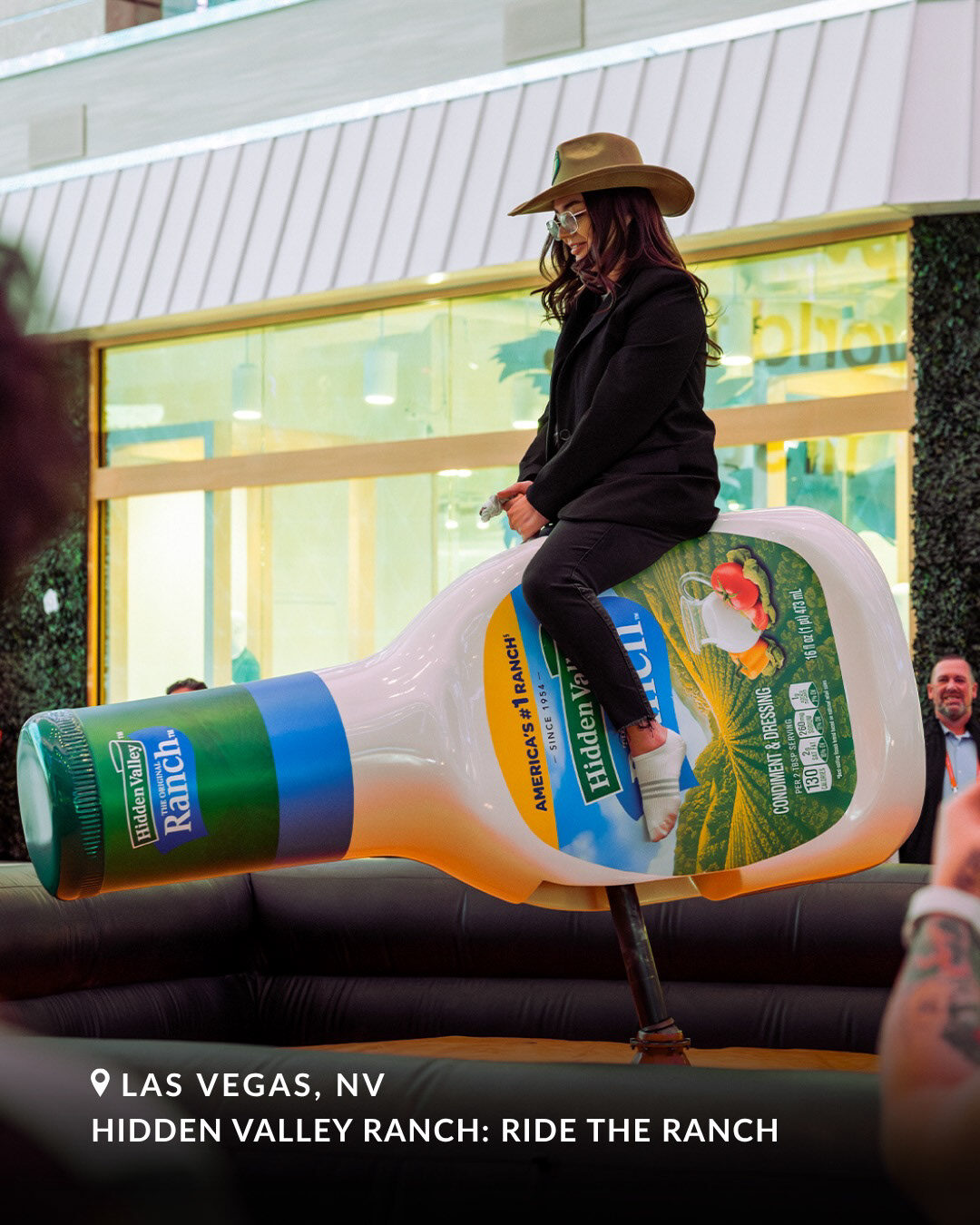 Guest riding the oversized Hidden Valley Ranch bottle in Las Vegas