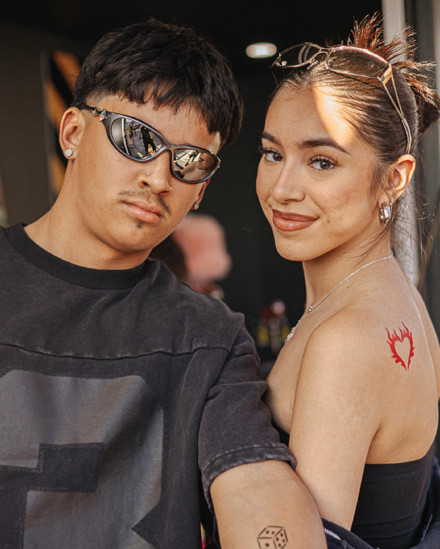 Festival guests showing temporary tattoos at SHEIN Street
