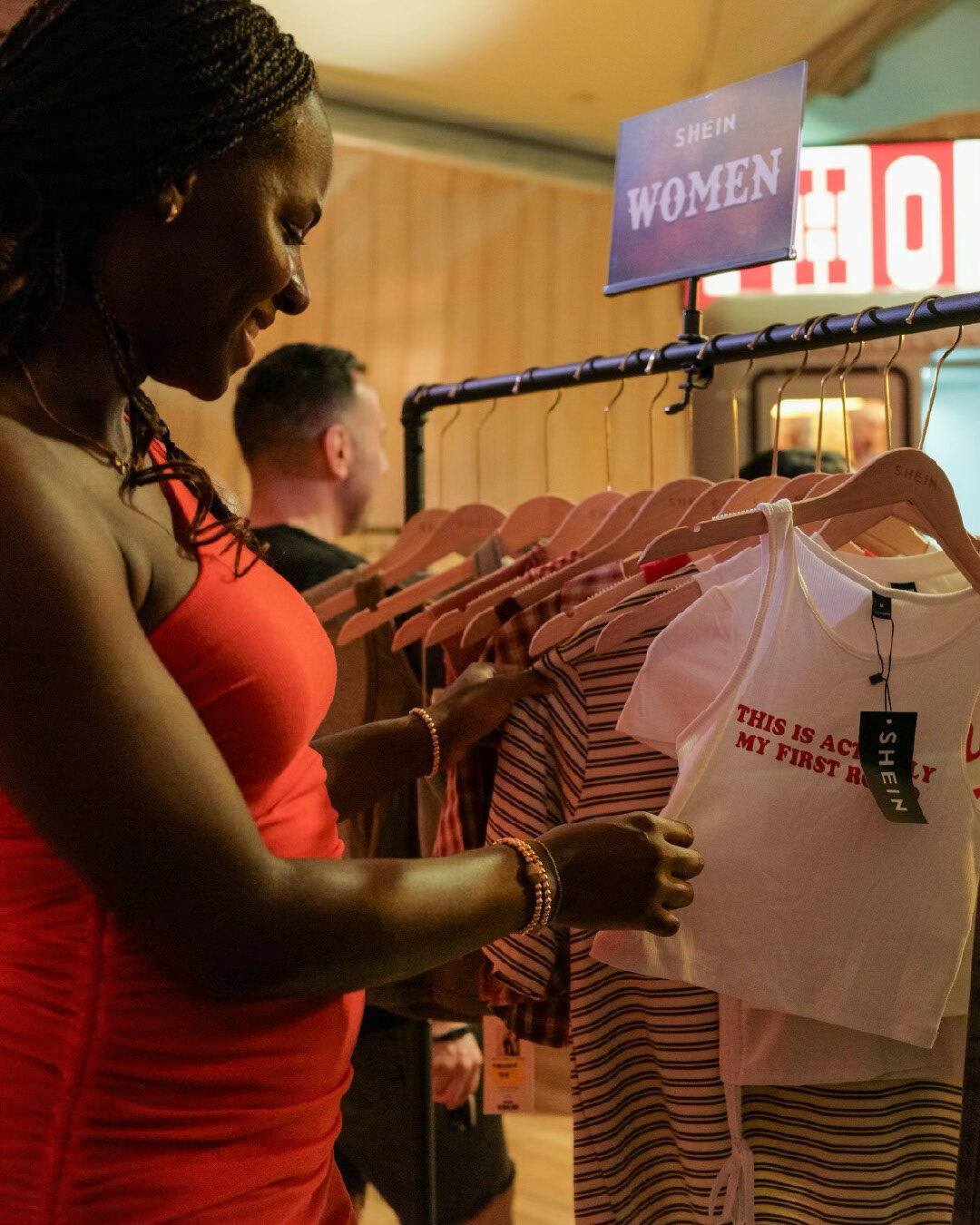 Guest browsing graphic tops inside the SHEIN Saloon