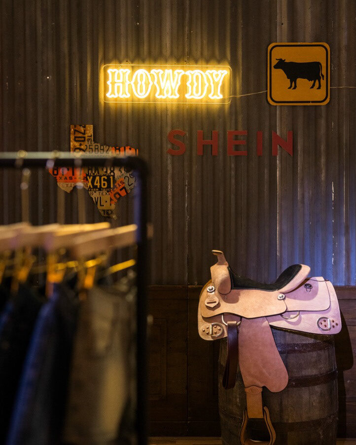 Western saddle photo moment with layered SHEIN signage
