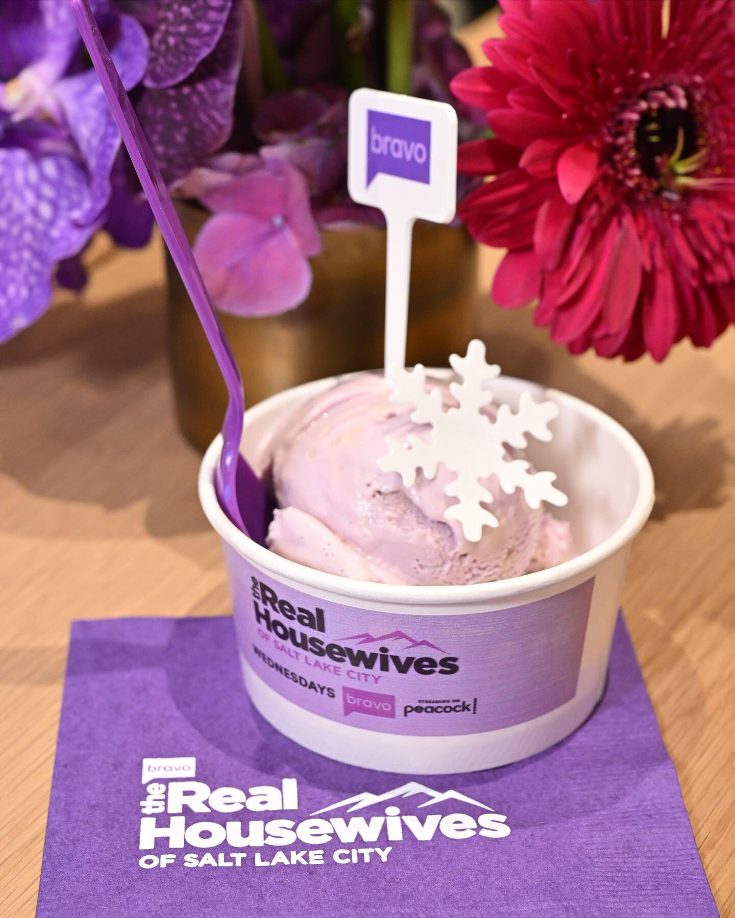 Scoop cup with Bravo pick and snowflake topper on a branded napkin