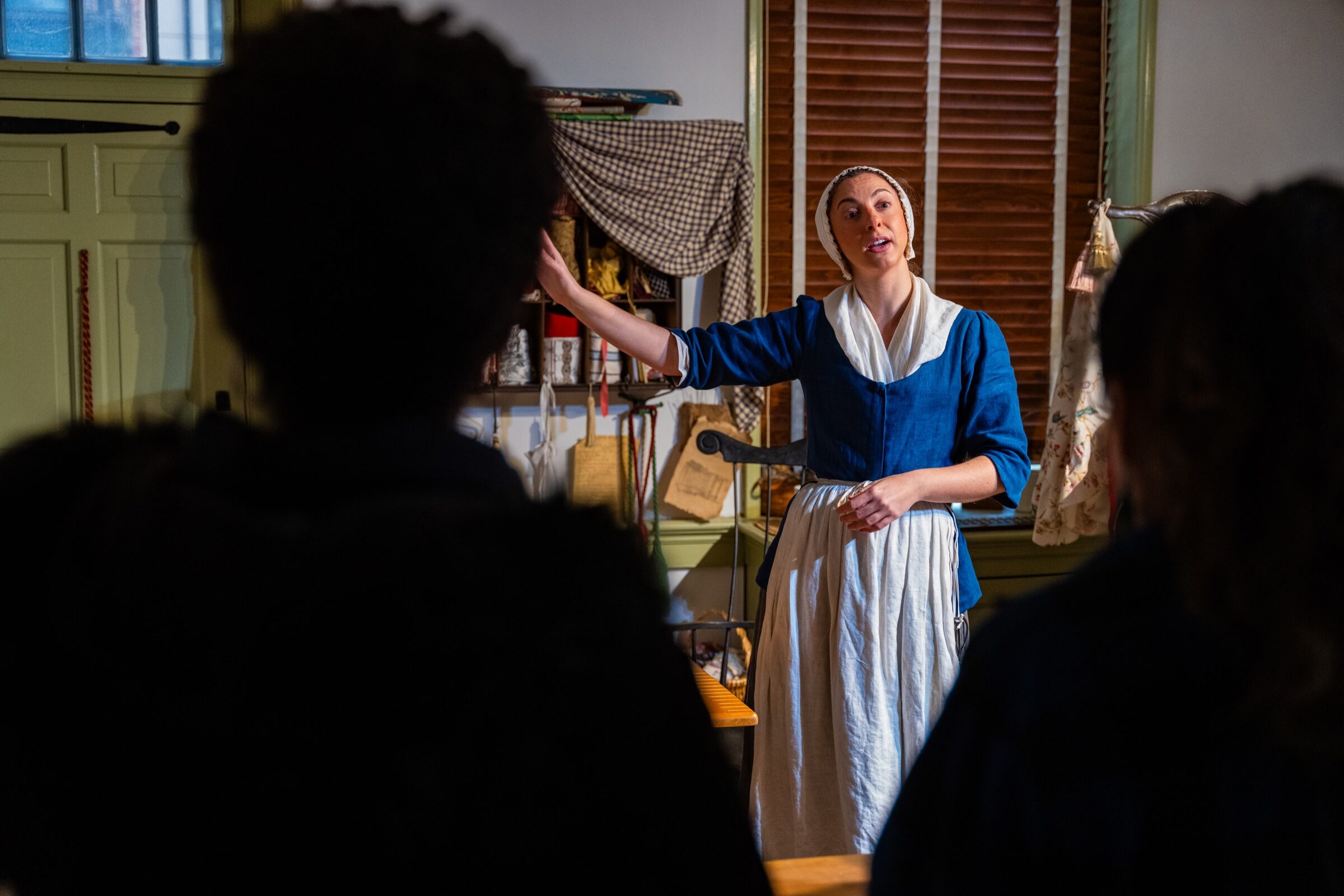 A guide welcoming guests inside the historic Betsy Ross House