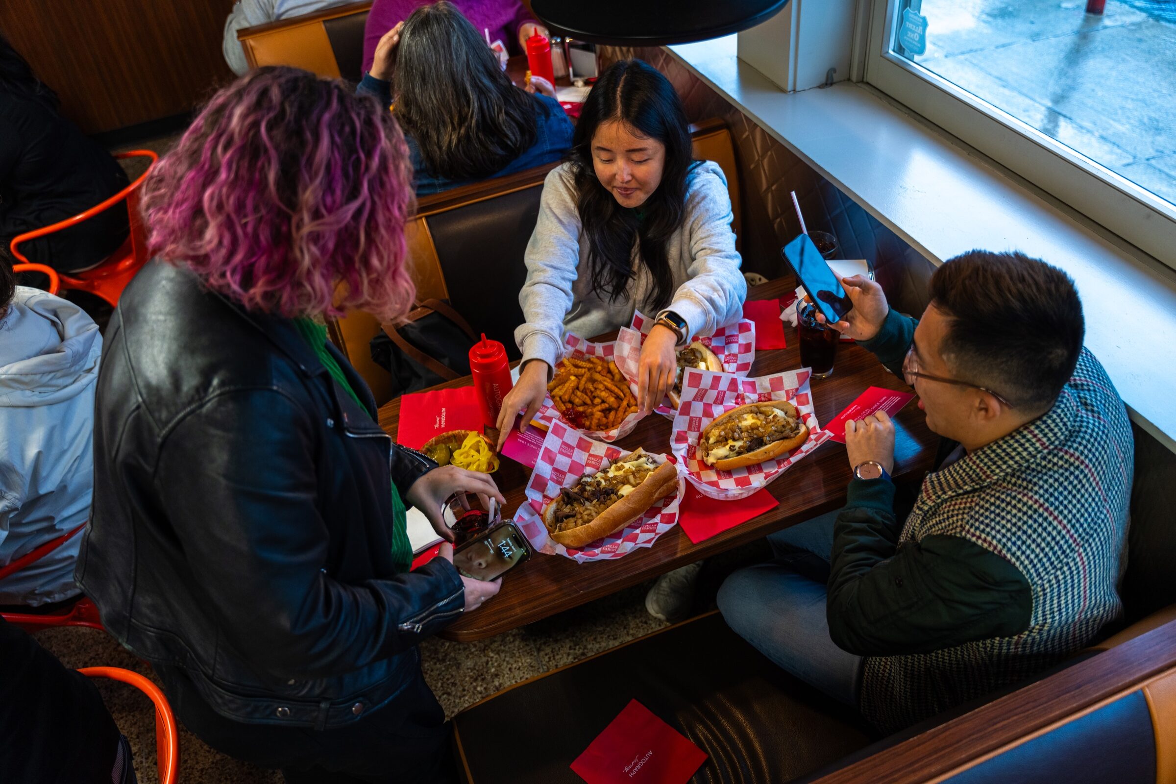 Guests sharing cheesesteaks during the Philadelphia itinerary