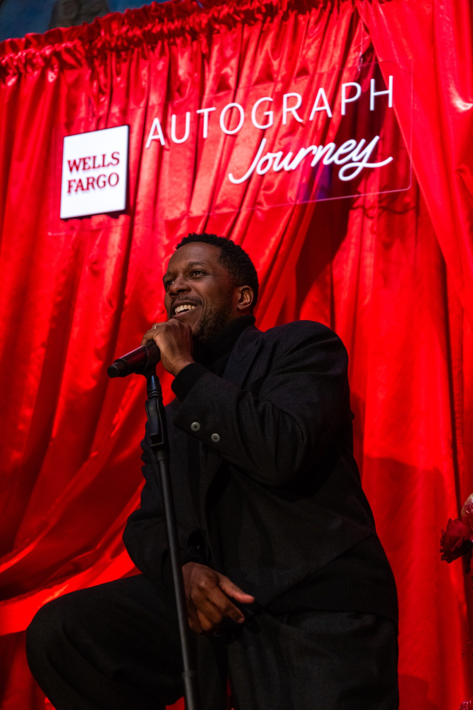 Close-up of Leslie Odom Jr performing an intimate acoustic set for Autograph Journey guests