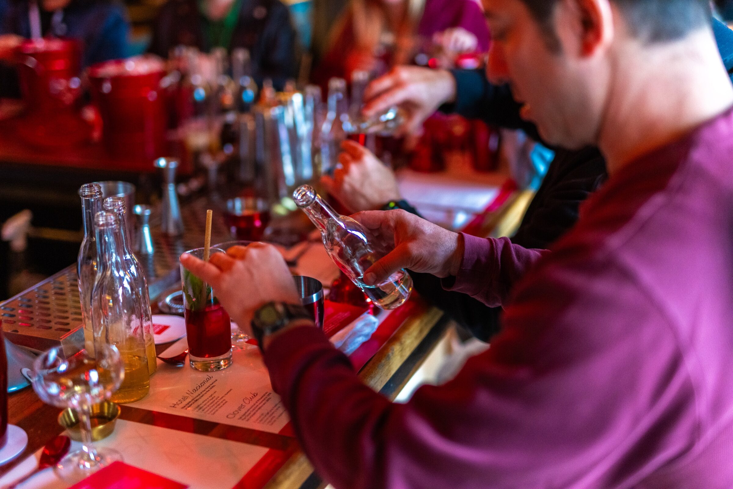 Guests mixing cocktails during a hands-on Autograph Journey class