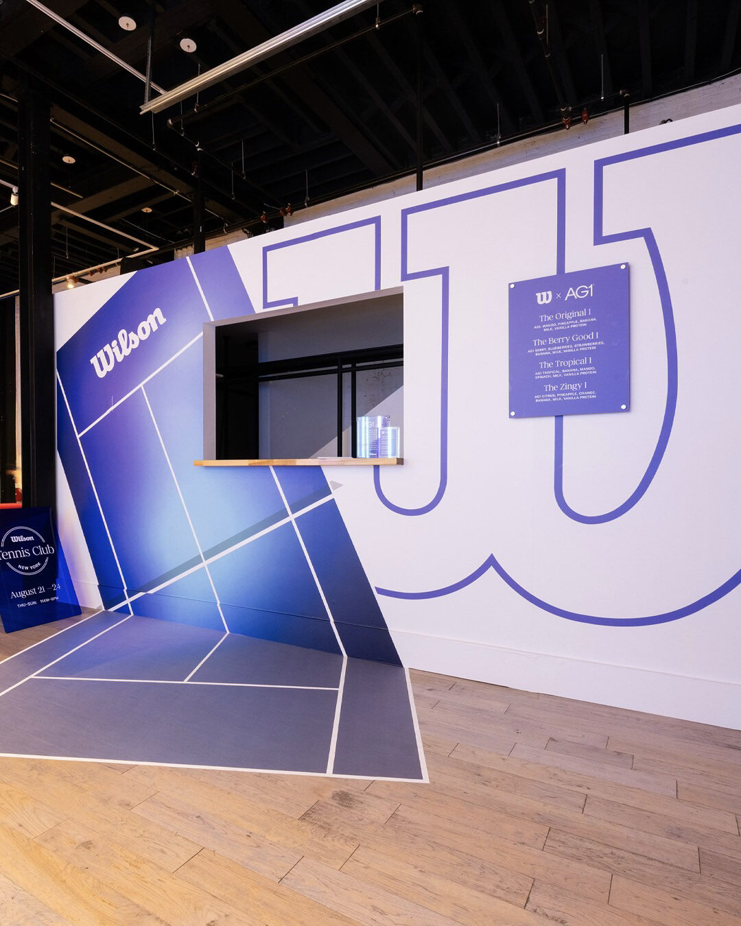 Wilson Tennis Club interior with oversized court graphics and wayfinding
